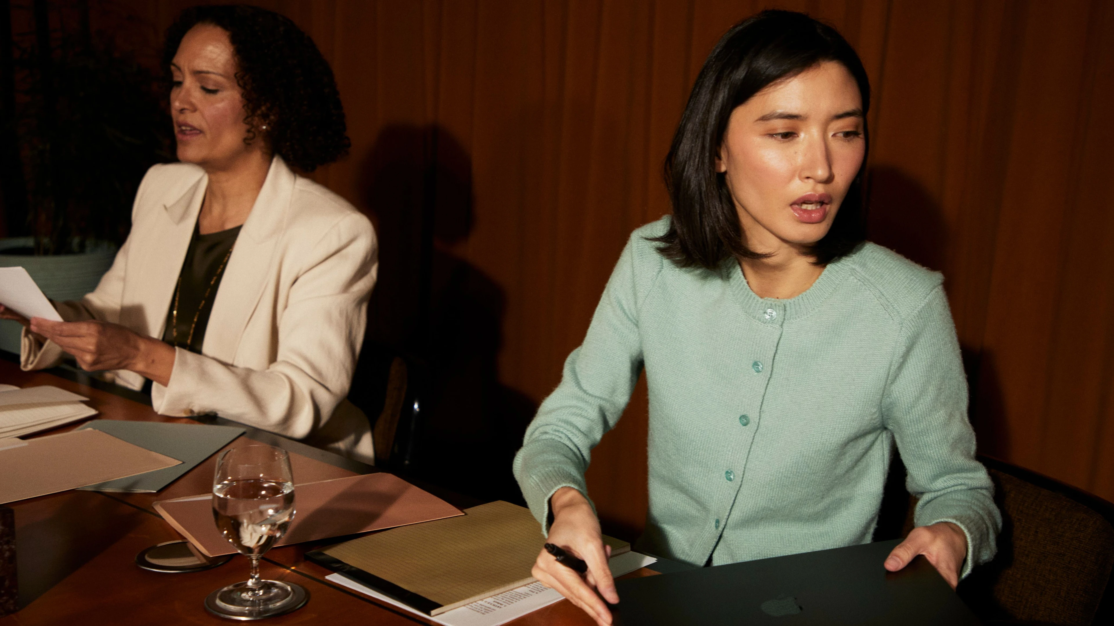 Coordinators reviewing contracts together at a boardroom table